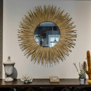 Contemporary living room featuring a unique sunburst mirror and chic decor accents.